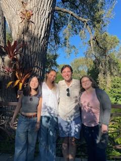 Irene, Veronika, Connor, and Megan stand in front of a large tree outside