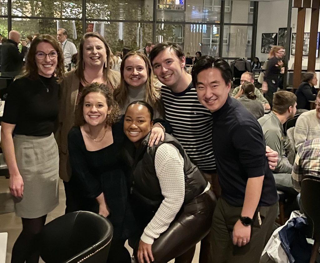 Brooke stands with the grad students, all smiling